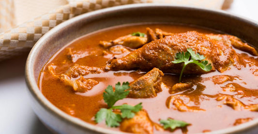 Curried chicken in a bowl on a table